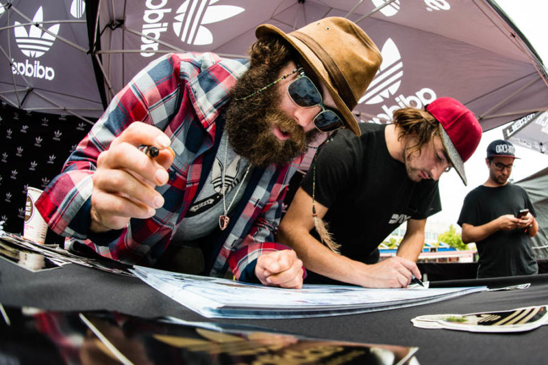 Forest Bailey and Santa Clause sign posters at the Adidas booth.