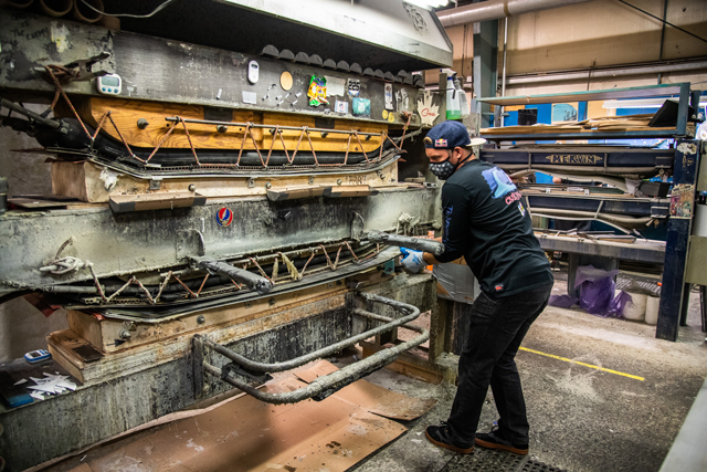 Lib Tech Orca snowboard in the snowboard press at Mervin Mfg