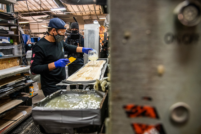 Travis Rice applying resin to Orca snowboard wood core