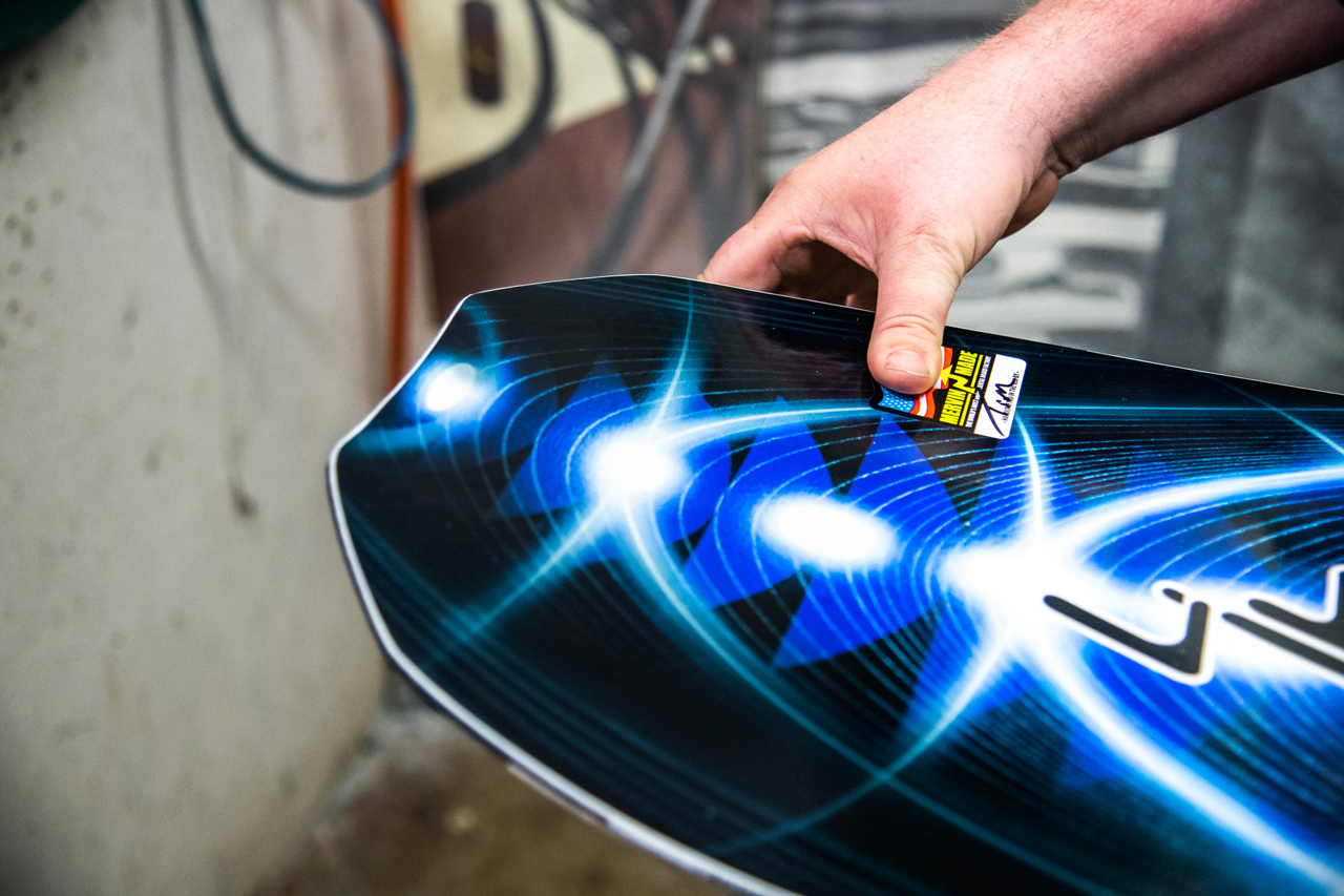 Tim McCabe adding his signature to the finished Orca Snowboard