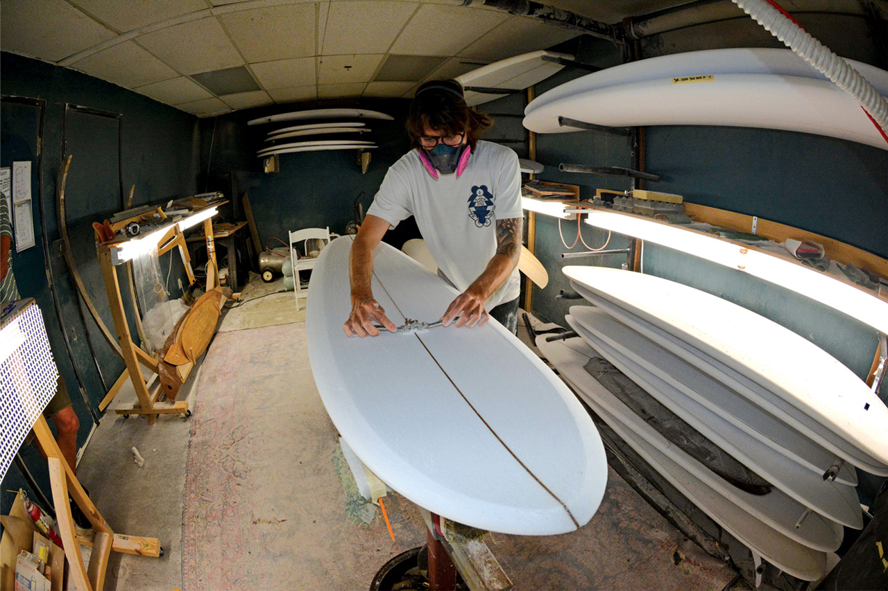Alex Lopez shaping a surfboard